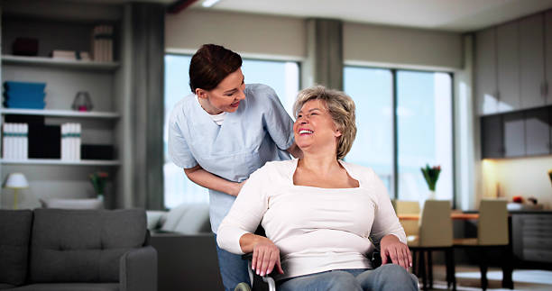 istock Smiling Caregiver Helping Older Patient 2212041277