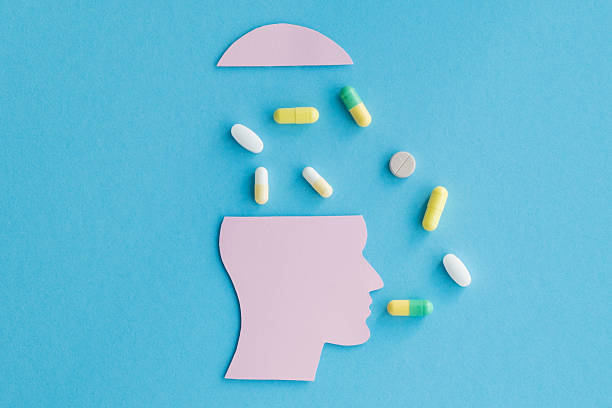 istock A head with pills falling out of it 2212045164