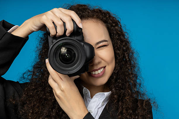 istock A girl in a black suit with a camera 2212045824