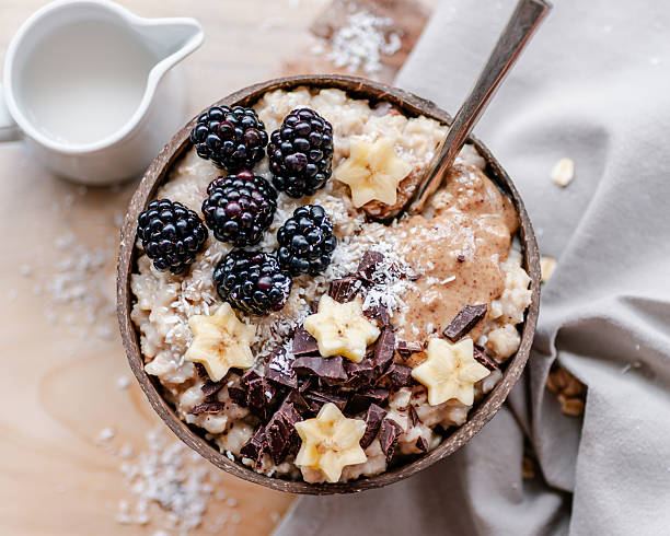 istock Creamy vanilla oatmeal bowl with nut butter, fruit and chocolate 2212047143