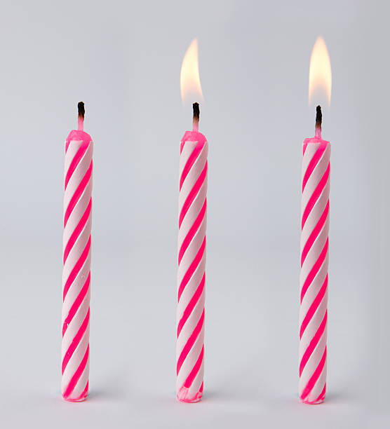istock Burning birthday candles isolated on white background. 2212048133