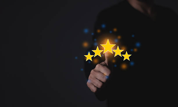 istock Happy Customer, Young Man using smartphone mobile hand touching five star to review and give 5 stars with very good results in service, Good review 5 star rating choice feedback 2212048532