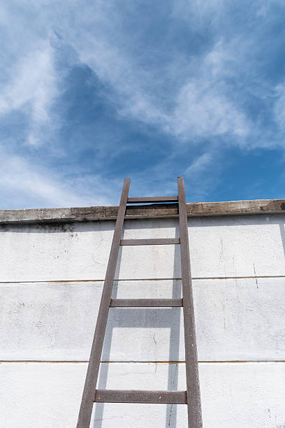 istock Weathered ladder leads to bright sky 2212050378