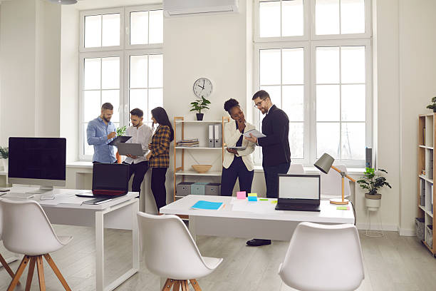 istock Diverse business team conversation at bright office view from distance 2212050526