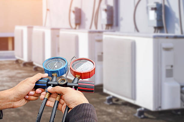istock Air conditioning, HVAC service technician using gauges to check refrigerant and add refrigerant. 2212051063