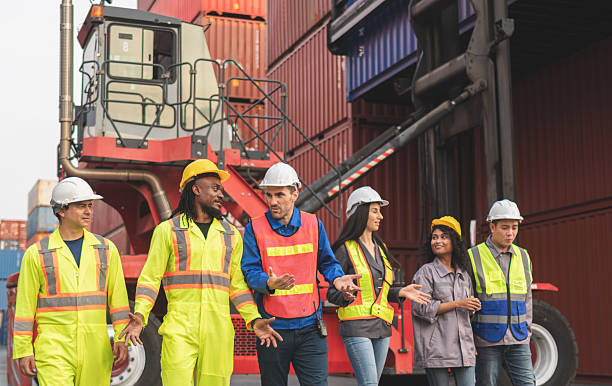 istock Group of engineer and foreman worker team in industry containers yard, Diverse team of workers collaborating at shipping container cargo 2212052195