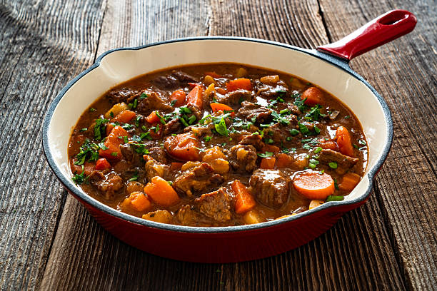 istock Beef goulash with vegetables in frying pan on wooden table 2212053995