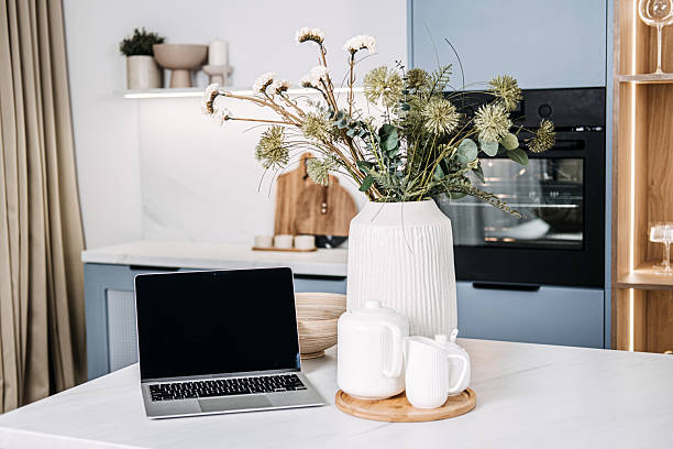 istock Kitchen Workstation Mockup with Empty Laptop Screen. An elegant kitchen setup with laptop empty screen ready for mockups, surrounded by tasteful home decor and natural light. 2212054719
