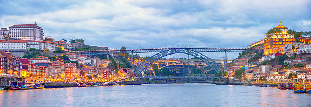 Porto cityscape over the Douro River and Dom Louis Bridge at night, Portugal. Composite photo