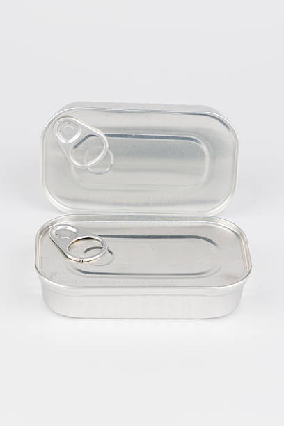istock Closed silver food can without label on white surface in center composition 2212056593