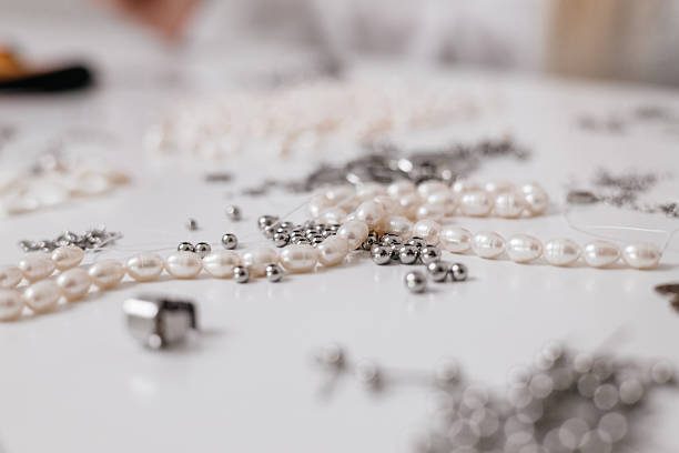 istock Jewelry Making Supplies with Pearls, Beads, and Tools close up 2212059002