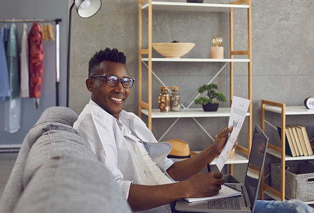 istock Happy successful black businessman working on couch in his comfortable home office 2212060256