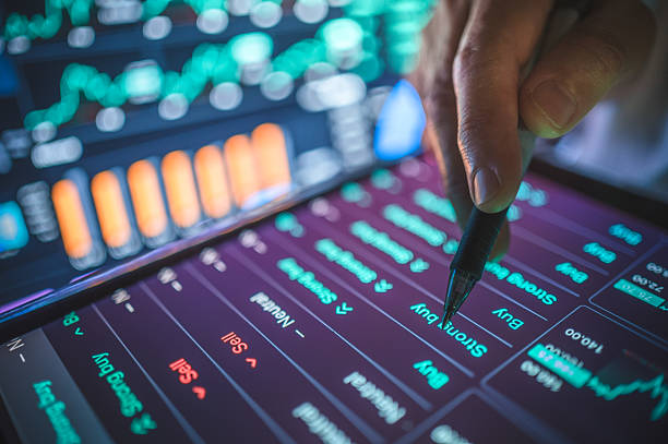 Business advisors using digital gadget to tracking financial goals with artificial intelligence and chatbot to track financial goals and investment performance. Suitable for themes of personal finance and financial planning