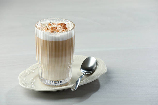 istock Tasty latte macchiato in glass on white table, space for text. Coffee drink 2212070940
