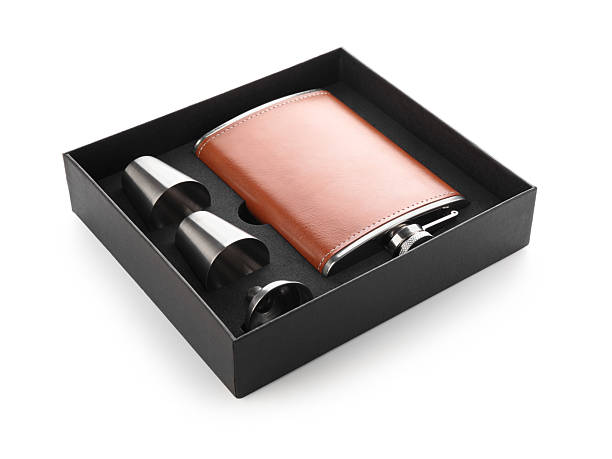 istock Hip flask, cups and funnel in package isolated on white 2212071466