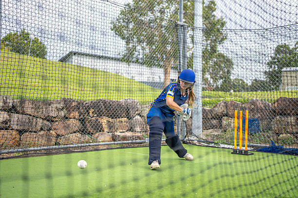 istock Girl Playing a Defensive Shot in Cricket Practice 2212071863
