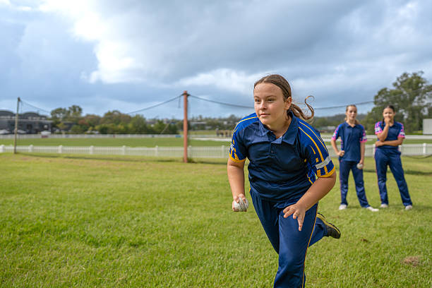istock Focused Girl Bowling During Youth Cricket Practice 2212071911