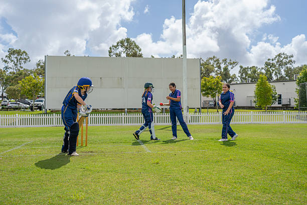 istock Girls Interacting During Youth Cricket Match 2212072531