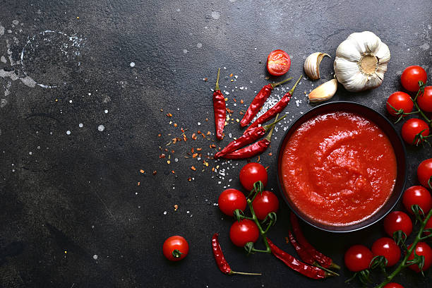istock Homemade spicy tomato sauce with ingredients for making. Top view with copy space. 2212073330