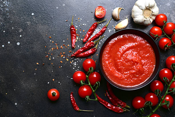 istock Homemade spicy tomato sauce with ingredients for making. Top view with copy space. 2212073431