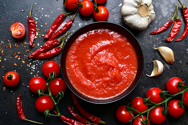 istock Homemade spicy tomato sauce with ingredients for making. Top view with copy space. 2212073433