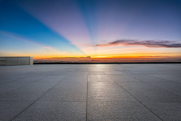 istock Empty city square at sunset with dramatic sky and colorful cloudscape 2212073852