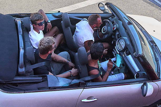 Crete.Greece - april 23, 2025: A group of young travelers cruise through sunlit streets in a convertible, embracing the joy of outdoor travel and exploration while sharing laughs and excitement