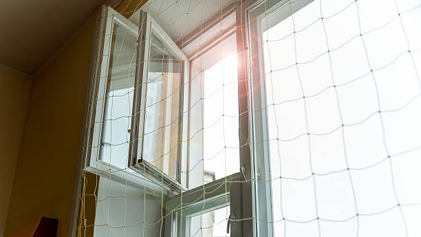 istock Bright sunlight filtering through window, child safety net preventing falls and protecting young lives in indoor setting 2212075856