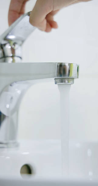 istock asian people turning on faucet 2212079069