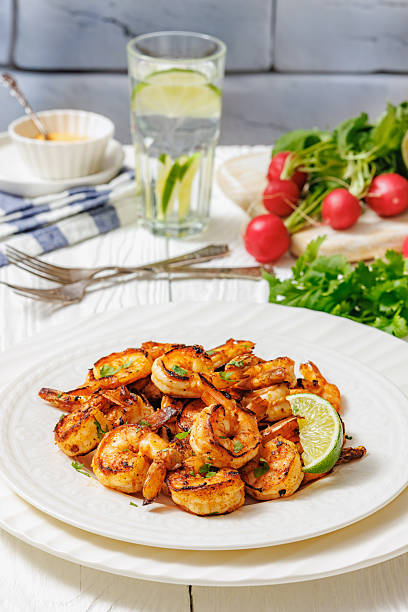 istock Grilled shrimp on a white plate with lime 2212079740