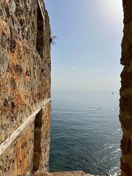 istock Historic Stone Wall Overlooking the Calm Sea with Natural Frame Effect 2212079855