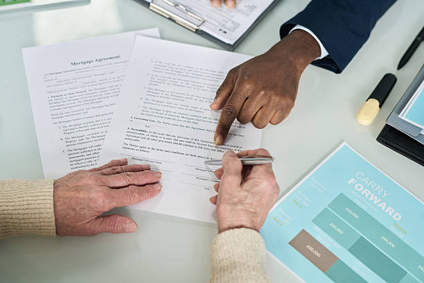 istock Senior Woman Signing Contract With Manager 2212080537