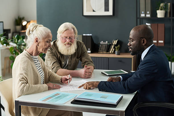 istock Senior Woman Signing Document At Meeting 2212080546