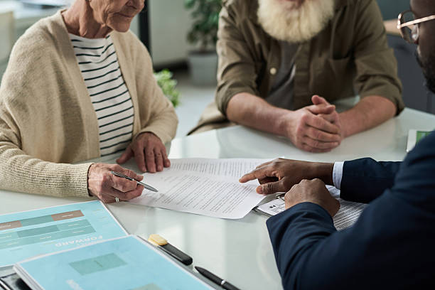 istock Senior Couple Signing Documents For Pension 2212080565