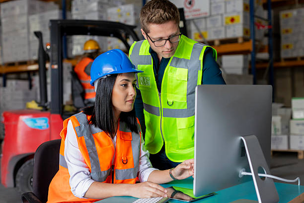istock Young Male and Female Warehouse Workers Collaborating on a Computer in a Warehouse 2212081752