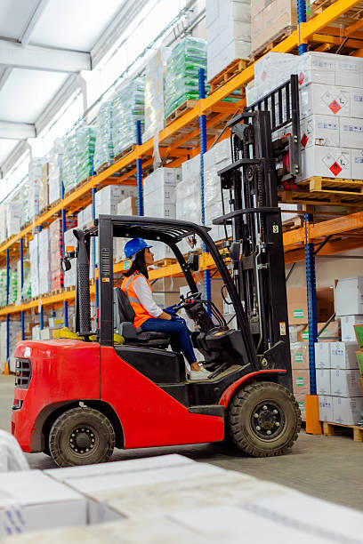 istock Female warehouse worker operating forklift in industrial storage facility. 2212081753