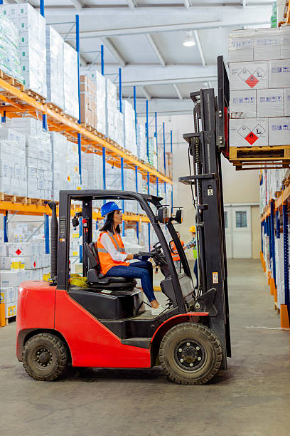 istock Female warehouse worker operating forklift in industrial storage facility. 2212081787