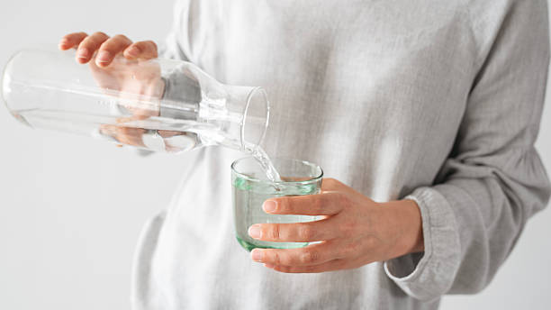 istock Young woman drinking water 2212085520
