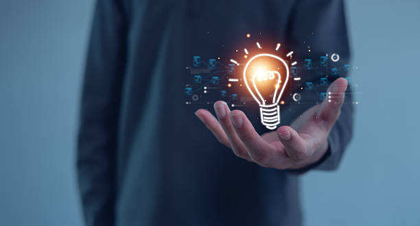 istock Hand of  holding illuminated light bulb, Idea innovation and inspiration concept.  creativity with bulbs that shine glitter, Concept for success. 2212089385