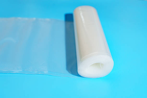 istock Roll film for a product vacuum sealer machine on a blue background. 2212090621