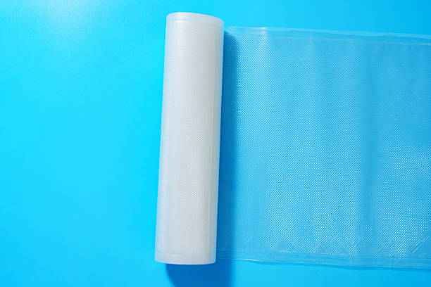 istock Roll film for a product vacuum sealer machine on a blue background. 2212090781