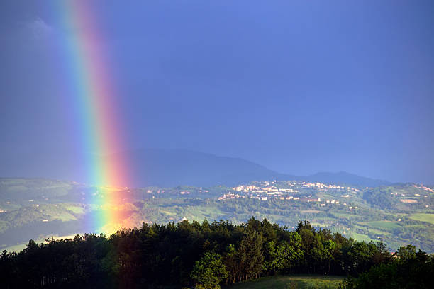 istock view of hilly landscape and rainbow in dark sky 2212090830
