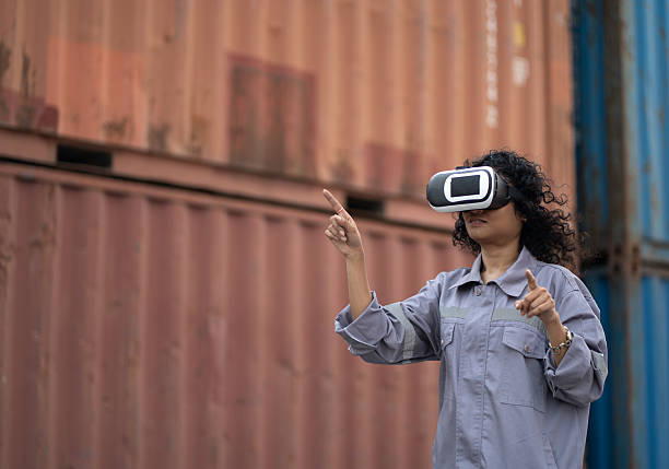istock Asia worker woman use VR headset working with checking container at container site 2212092204