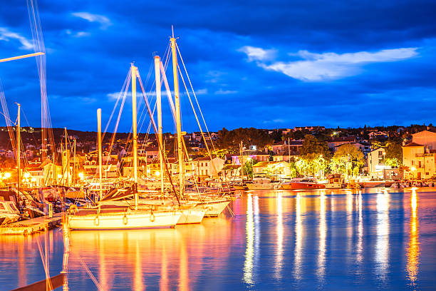 istock Croatia. Malinska waterfront and sailing harbor blue dawn view 2212095646