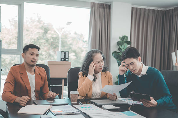 istock Business team is working hard and stressed with documents about business finance and marketing with project issues. Business team is meeting and discussing project plans. Finance manager's job. 2212097357