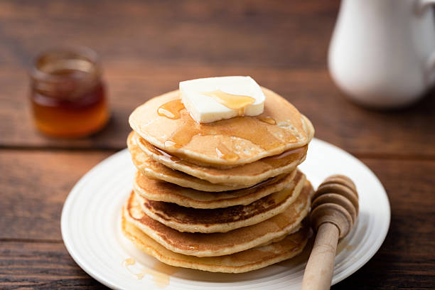 istock Stack of pancakes with butter and honey 2212099152