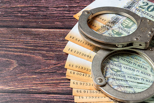 istock Hungarian 20.000 Ft banknotes and handcuffs 2212101437