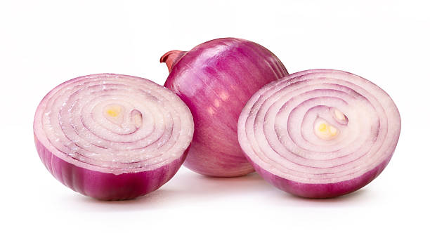 istock Single fresh peeled red or purple Spanish onion bulb with two onion halves in stack isolated on white background with clipping path 2212102994