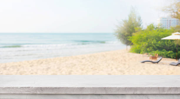 istock Selective focus.Marble top table on blur sea beach landscape 2212108487