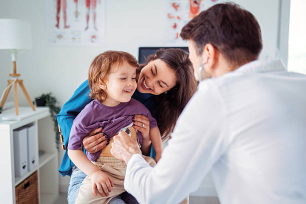 istock Mother and Young Son Talking with Doctor During Checkup 2212114238